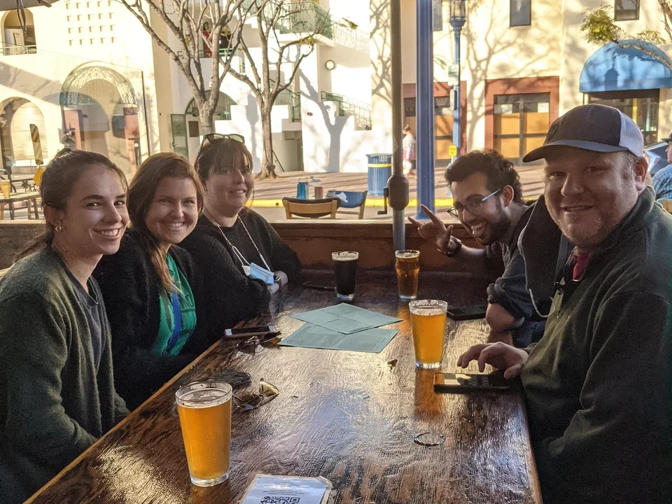 Lab members sit at bar drinking beer for first gathering at Barne April 2021.
