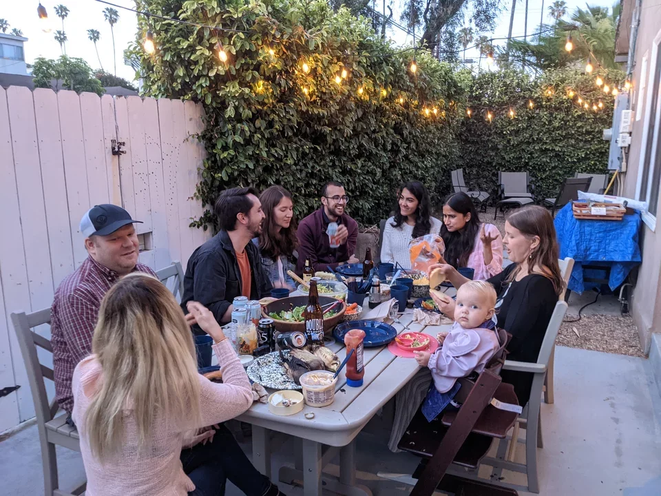 Lab members sitting outside at gathering at Manish's house in May 2021.