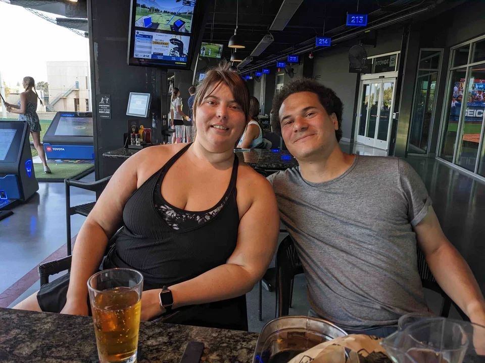 Female and male lab members enjoying a beer at Top Golf, El Segundo Sep 2022