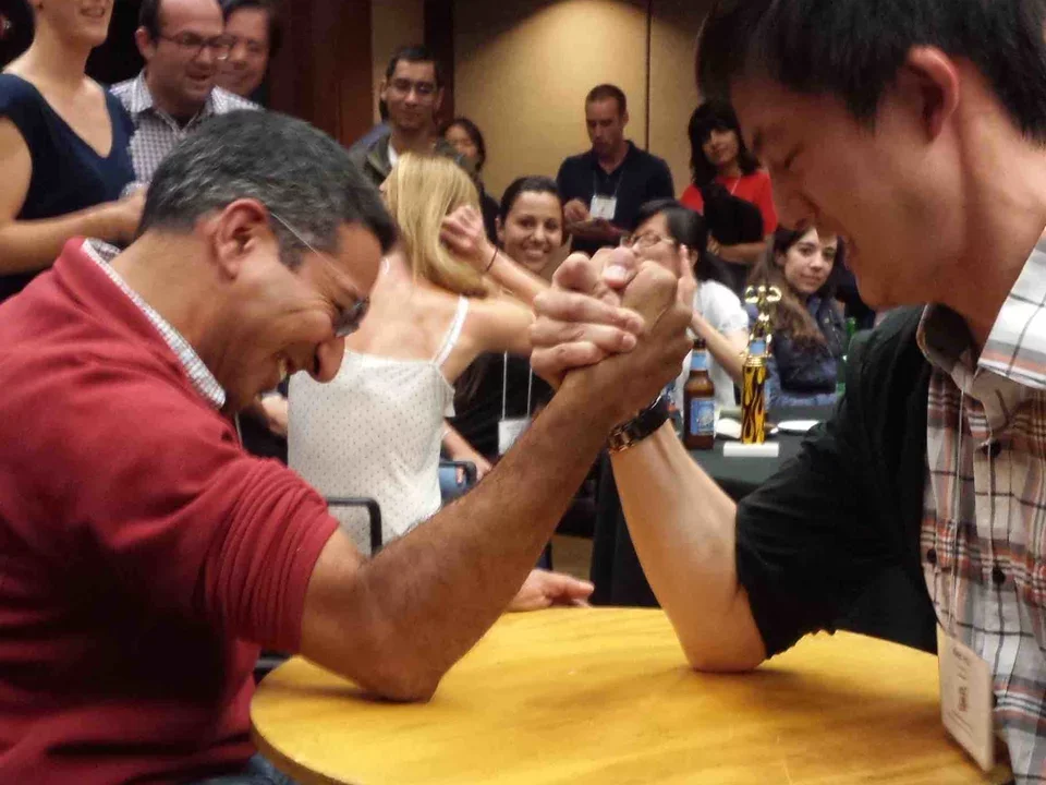 Two men arm wrestling at table in Asilomar. Ken wins. Sep 12, 2014