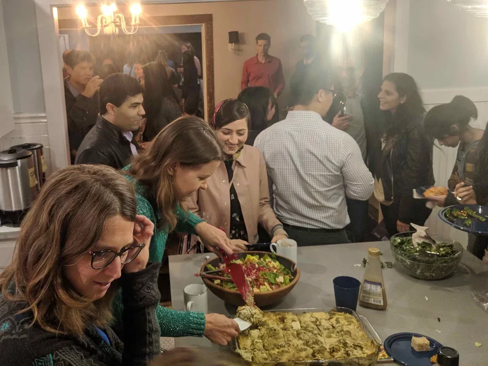 Group of people (56 in total) eating at holiday dinner, December 2018.