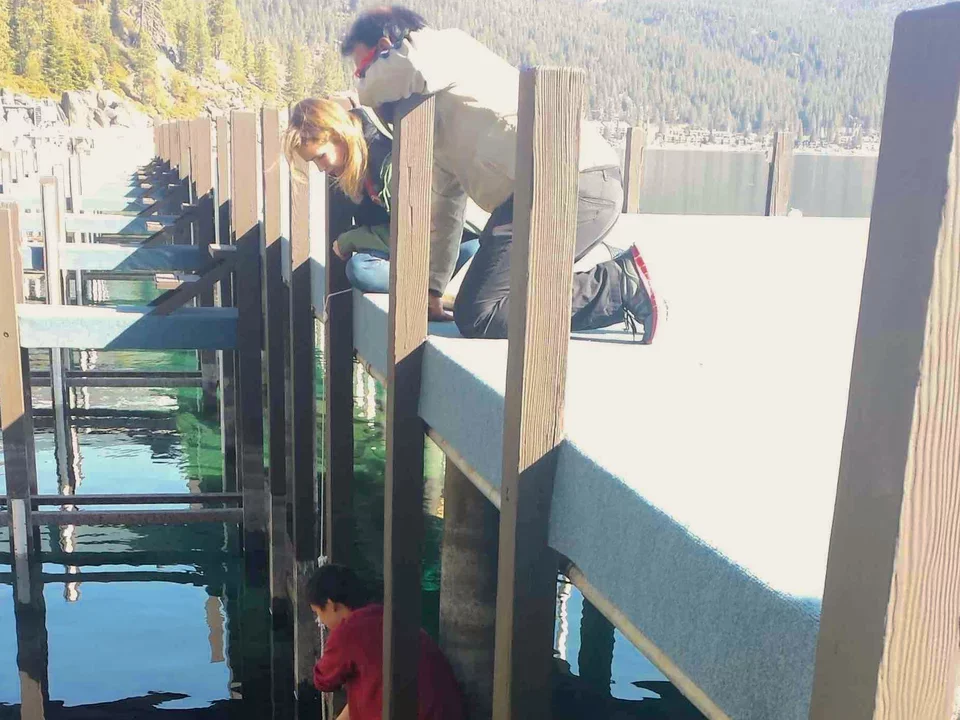 Ken sets his crayfish traps under pier on March 15, 2014.