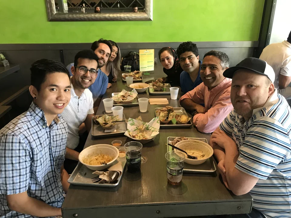 Lab fellows eating at lunch table as they say goodbye to Kevin on Sep 2019.