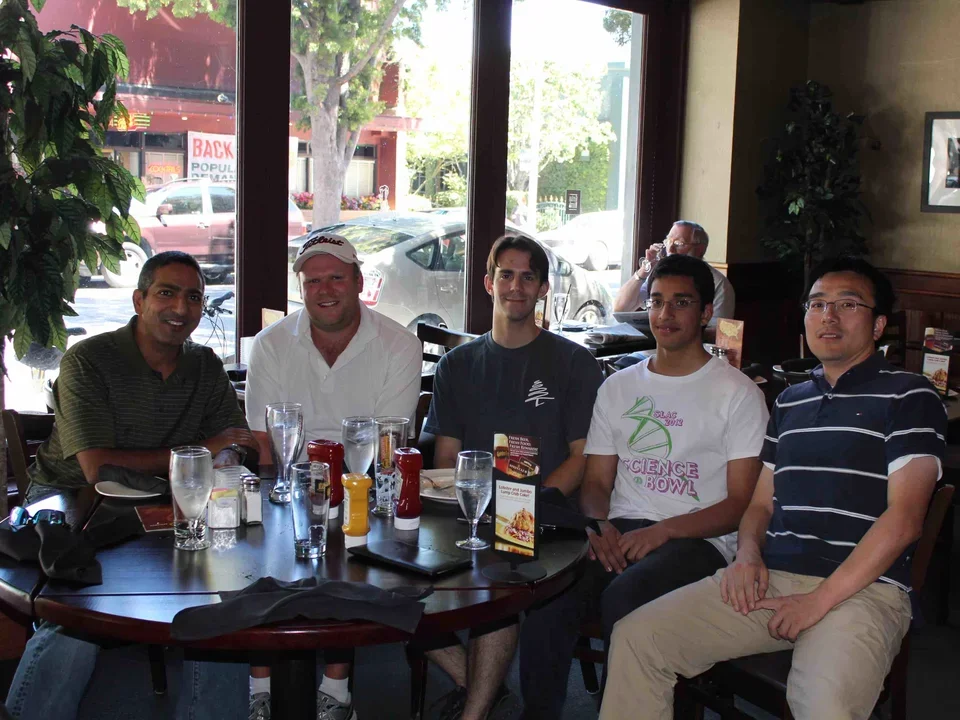 Group of scholars around lunch table with Keegan Mendonca at the end of summer Aug 6, 2012.