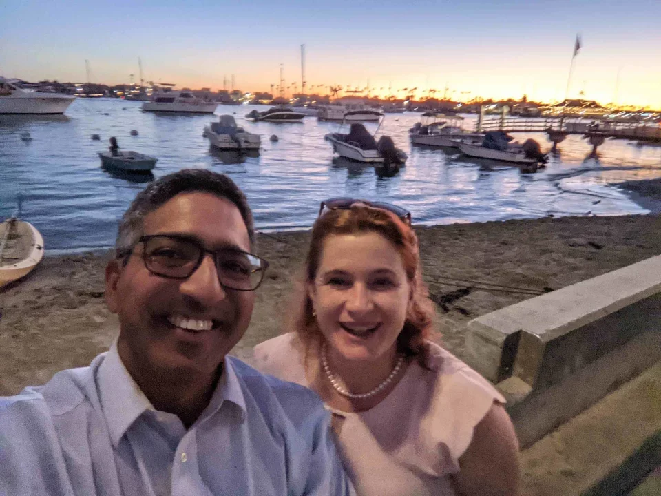 Manish standing in front of boat pier with collaborator Jolan Walter from University of South Florida, Nov 2021.