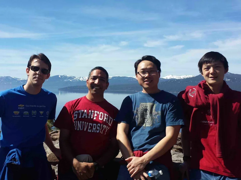 Group of male scholars from Butte lab and Bollyky labs stand in front of lake on first annual Tahoe trip, Mar 15, 2014.