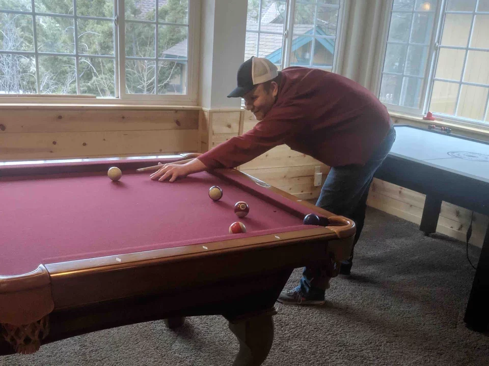 Butte Lab's Project Scientist Tim plays pool, provoking the question: Who is going to bet against Tim? Taken Mar 2019.